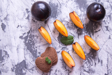 Shortbread cookies in the shape of a heart and plum slices with mint leaves