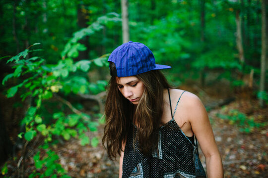 Brunette female hipster walks through wilderness