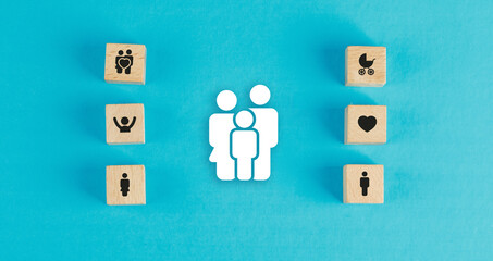 Family concept with wooden blocks, paper family icon on blue background flat lay. horizontal image