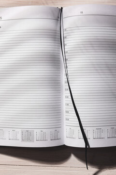 2015 leather personal black note book organizer on wooden background.