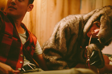 Two young drunken friends sit up and drink out of the bottle