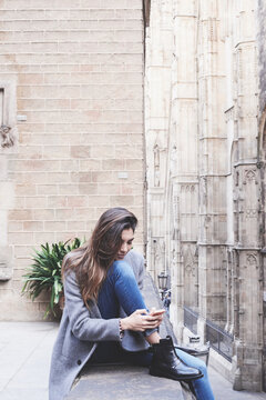 Woman using her mobile phone in the streets of BArcelona