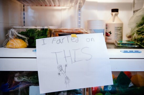Child tapes ""I farted on THIS"" sign on food in refrigerator