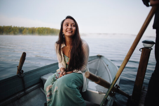 Beautiful native American girl waits patiently on her row boat