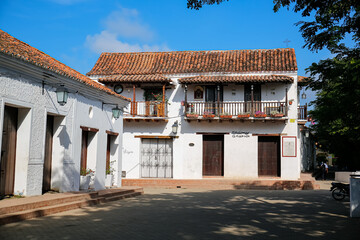 Beautiful old white buildings in sunlight, trees in shadow, Santa Cruz de Mompox, Colombia, World Heritage