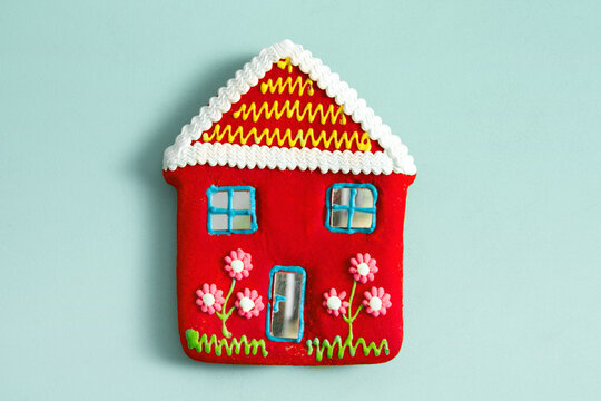 red candy house on baby blue background with copyspace