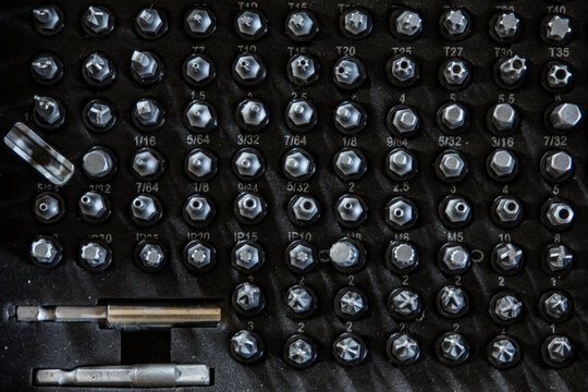 Collection of drill bits organized in a mechanic's suitcase