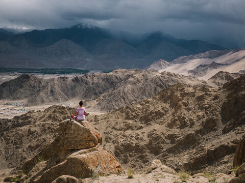 Yoga Girl Meditating on top of Mountains