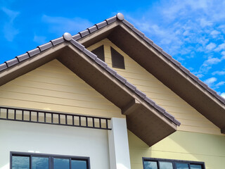 The roof of the house features The roof of the house features triangles and the sky. and the sky.