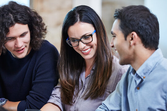 Group of millennial friends at work looking at cell phone