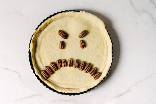 frowny face pecan nuts in a pie pastry
