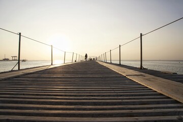 wooden bridge on the beach on the sea.