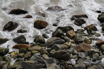 Waves from the Sea Crashing over Rocks on the Coast