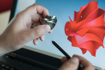 Engineer is constructing an industrial turbine component