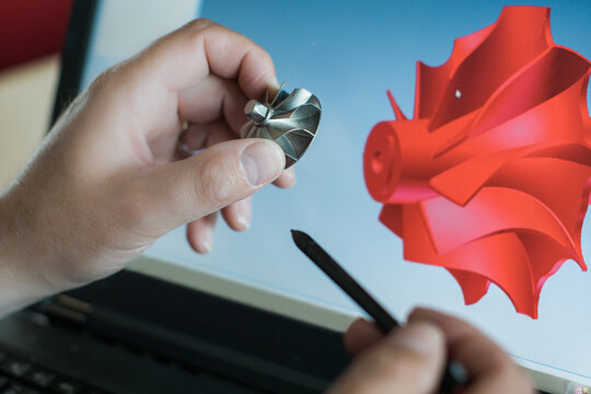 Engineer is constructing an industrial turbine component