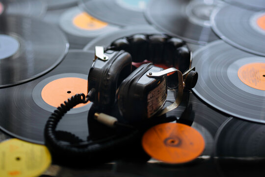 Old big headphones on vinyl records