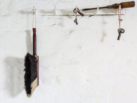 Old-fashioned hand brush hanging on a hook