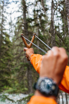 Man pulling back a sling shot