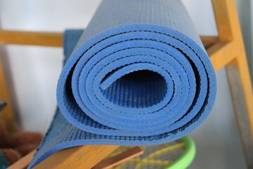 blue yoga mat lying unused in storeroom of home