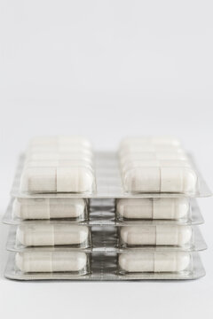 Closeup of white capsules in blister pack