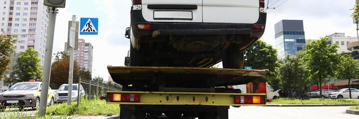 Minibus is on tow truck. Towing and towing cars concept