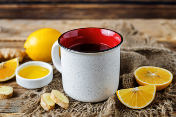 Cup of black tea with honey, lemon and ginger