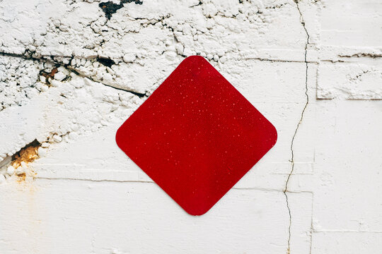 Red caution sign on building wall