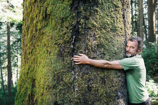 Man hugging tree