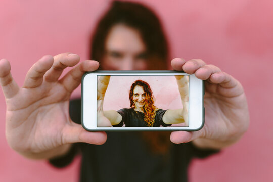 Woman taking a selfie with cell phone