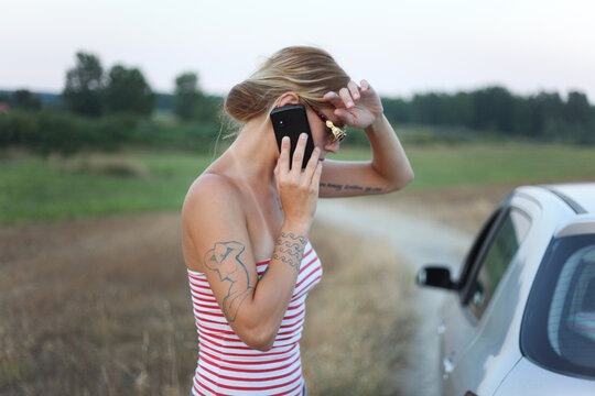 Handsome tattooed woman talking on a phone