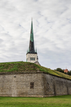Spire of St. Olav's church (Oleviste kirik) in Tallinn is seen behind the town wall
