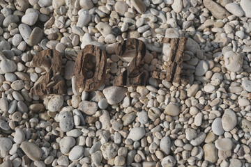 On the stones are the numbers 2021. New Year at sea.
