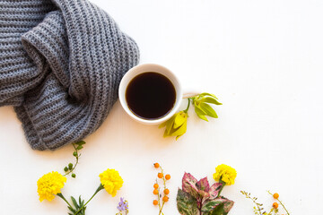hot coffee ,knitting wool scarf ,ylang ylang flowers ,marigold and leaf of lifestyle woman relax in...
