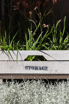 Plants in a wooden crate with a storage stamp