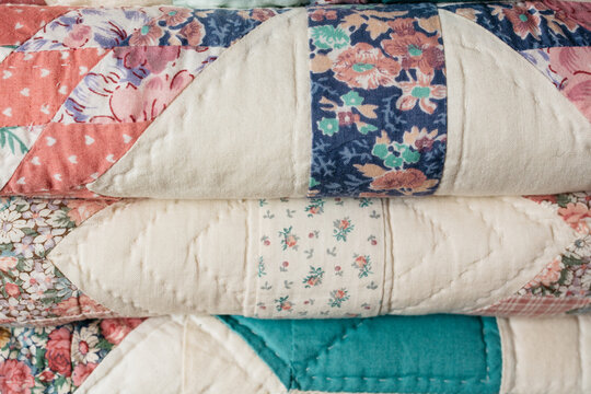 Various antique folded quilt blankets