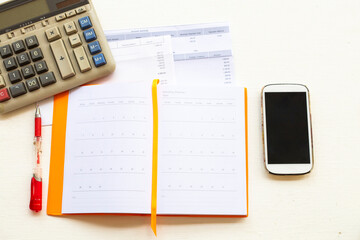credit card statement due expenses ,calculater ,notebook planner and mobile phone for business work arrangement at office desk on background white 