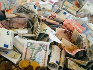 a huge pile of coins and banknotes