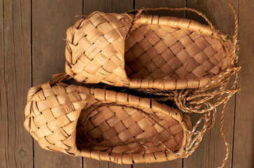 bast old shoes on brown wooden floor close up