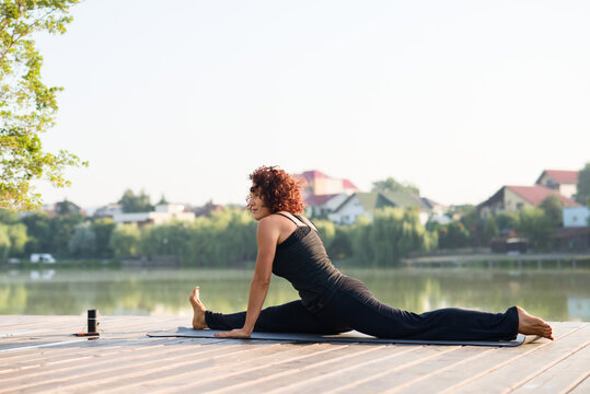 Woman doing yoga or pillates stretching outdoor