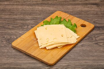 Sliced yellow cheese over board