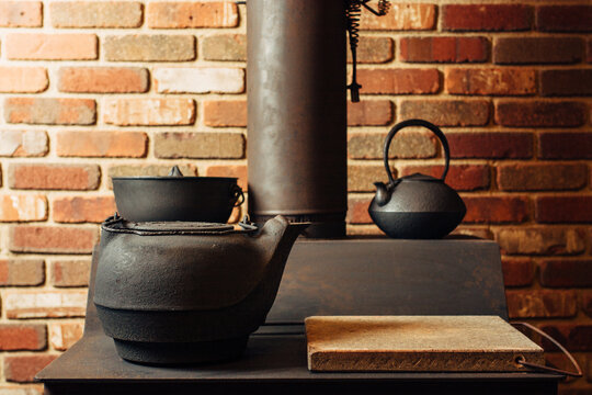 Cast iron teapots on a wooden stove