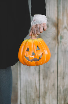 hand of young woman with pumpkin