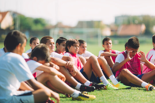 Young Football Players Sitting on the Ground