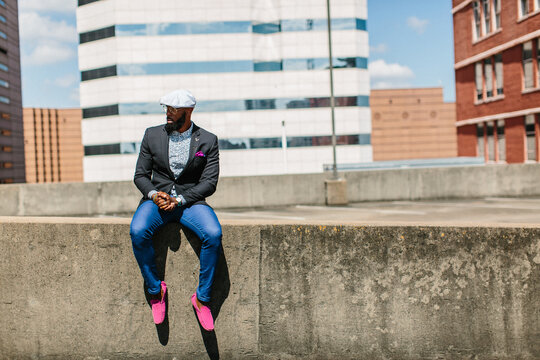 Portrait of a dapper young gentleman sitting outdoor