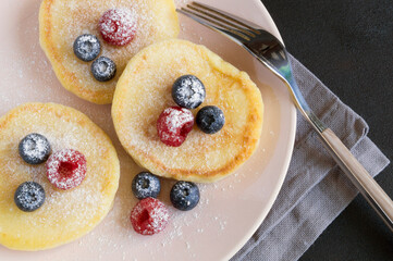 Cottage cheese pancakes, syrniki with fresh berries.
