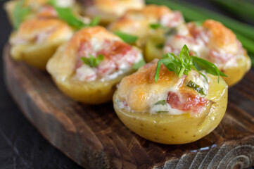 Hot baked stuffed potatoes with cheese, bacon, parsley.
