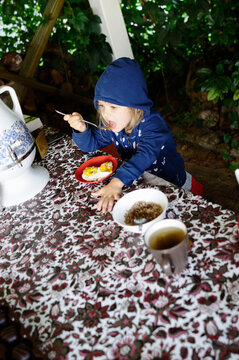 Little girl eating fried eggs