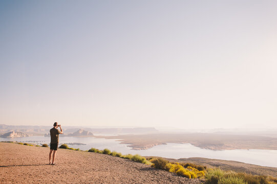 Man Taking a Photo of Lake Powell, Utah Overlook