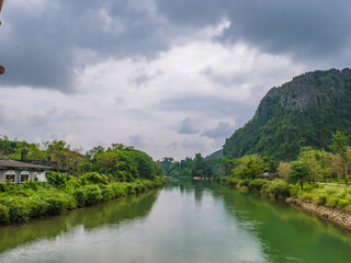 Fototapeta na wymiar Beautiful view of nam song river with mountain view at Vangvieng city Lao.Vangvieng City The famous holiday destination town in Lao.