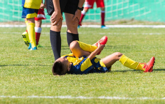 Sufferer Child Football Player On The Field.